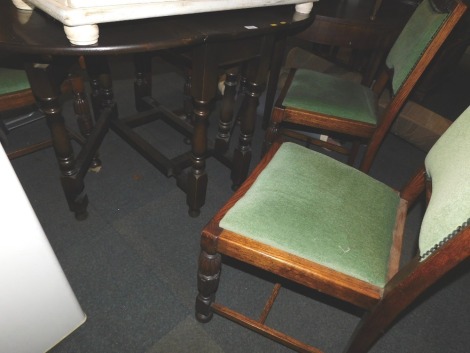 An oak drop leaf table, together with four green upholstered dining chairs. (5)