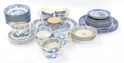 A group of blue and white wares, comprising Old Chelsea pattern cups and saucers, English Ironstone Old Willow pattern wares, etc. (a quantity)