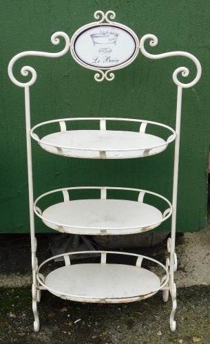 A Labane cast metal bathroom three shelved unit, with enamel top plaque, and scroll detailed supports, 111cm high.