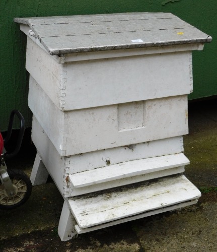 A white painted three tier bee hive, with a felt and silver lined roof, 83cm high, 61cm wide, 70cm deep.