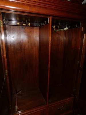 A Victorian walnut double wardrobe and dressing chest, by Blair and Kemp, Horncastle, the wardrobe with outswept pediment over a pair of carved and mirror set doors, the doors opening to reveal hanging hooks over a pair of deep drawers raised on a plinth - 4