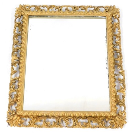 A Victorian gilt wood and gesso wall mirror, rectangular with foliate outer surround, on a rectangular later mirror plate, 58cm x 50cm.