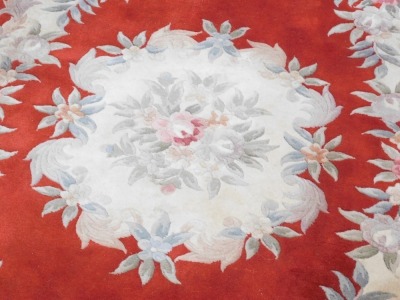 A Chinese cut wool rug, on a red ground with cream flowers, and tassel ends, 187cm x 125cm. - 2