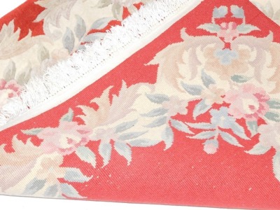 A Chinese cut wool rug, on a red ground with cream flowers, and tassel ends, 187cm x 125cm. - 4