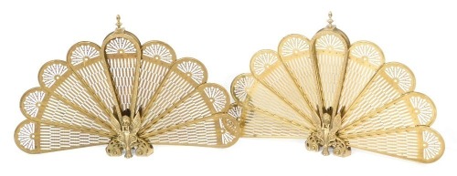 A pair of brass fireside fan guards, each with a phoenix centre and nine fan section, 64cm high, 93cm wide. (2)