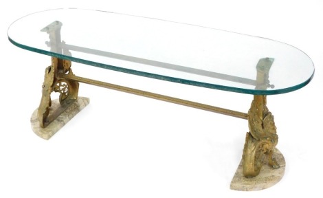 A Empire style coffee table, the oval glass top above two brass figural chenets, on a demi lune marble base, 48cm high, 127cm wide, 47cm deep.