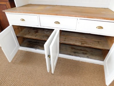 A Victorian painted pine kitchen dresser, the dresser back with a moulded cornice above two waterfall shelves, painted in white with a substantial three plank pine top, above arrangement of three drawers over a pair of twin cupboard doors, the base painte - 4