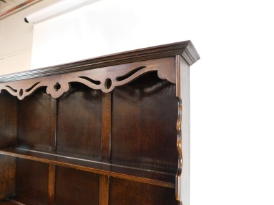 An early 20thC oak dresser, the dresser plate top with pierced and carved frieze over two shelves, above two drawers, on ring turned legs united by an under tier, 194cm high, 121cm wide, 45cm deep. - 3