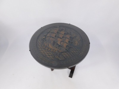 A mid 20thC Chinese tilt top occasional table, the circular top carved with a central ship in rough seas, glass protector, on an out folded base, 60cm diameter, 90cm high. - 3