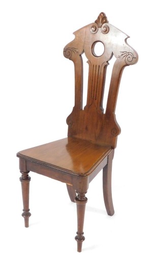 A Victorian mahogany hall chair, with a carved and pierced back, solid seat, raised on turned legs, 105cm high.