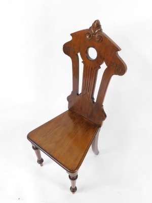 A Victorian mahogany hall chair, with a carved and pierced back, solid seat, raised on turned legs, 105cm high. - 2