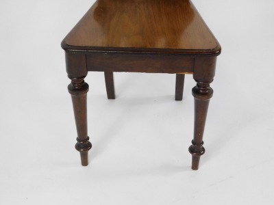 A Victorian mahogany hall chair, with a carved and pierced back, solid seat, raised on turned legs, 105cm high. - 3