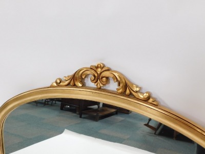 A Victorian style gilt framed oval mantel mirror, the arched top with foliate detailing, 106cm high, 140cm wide, 7cm deep. - 2