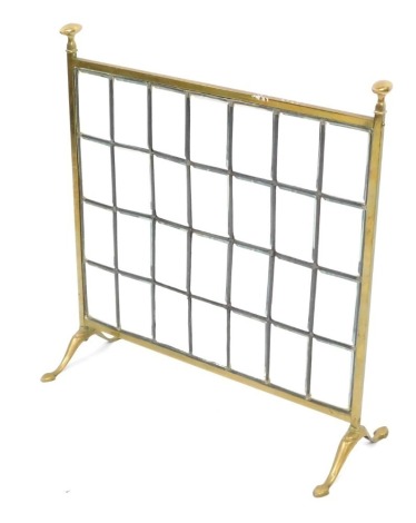 A Victorian brass and glass fire screen, the glass insert on brass supports, on out splayed feet, 67cm high, 63cm wide, approx 20cm deep.