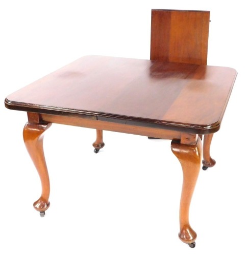 A Victorian mahogany wind out dining table, with one additional leaf, raised on cabriole legs, 71cm high, 152cm wide, 101cm deep.