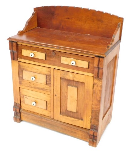 A Victorian oak washstand, the crenelated gallery over an arrangement of four small drawers and a cupboard, varying staining and colouring, raised on block feet, 90cm high, 76cm wide, 40cm deep.