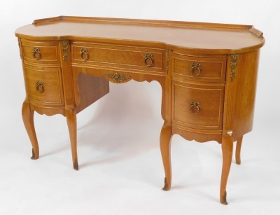 A French style mahogany bedroom suite, comprising dressing table and chest of drawers, the dressing table with long central drawer and two curved out panels, each with two drawers, with Neo Classical brass spandrels, 80cm high, 131cm wide, 42cm deep, the - 2