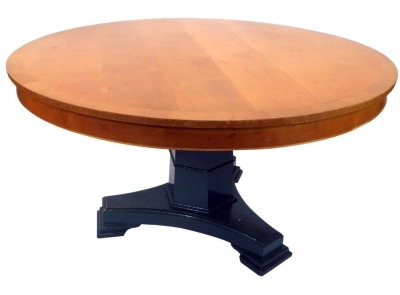 A large circular satin birch kitchen table, the top with a cross banded border, on a painted grey triform base, 80cm high, 137cm diameter.