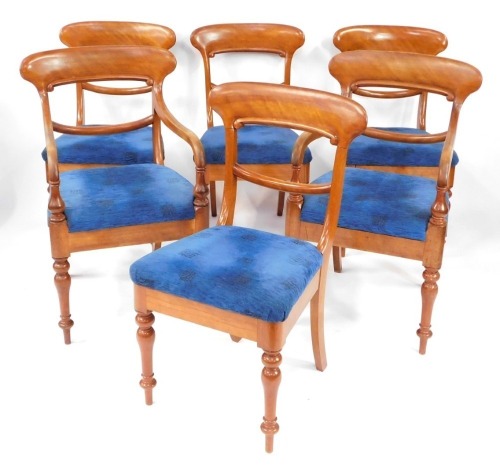 A set of early Victorian mahogany dining chairs, with blue upholstered overstuffed seats, raised on turned legs, comprising a pair of carvers and four single chairs.