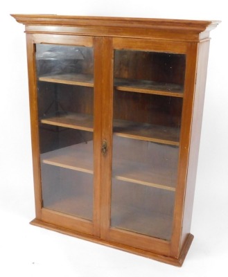 A Victorian mahogany wall hanging bookcase, the out swept pediment above two glazed doors, enclosing three shelves, 118cm high, 97cm wide, 31cm deep.