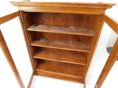 A Victorian mahogany wall hanging bookcase, the out swept pediment above two glazed doors, enclosing three shelves, 118cm high, 97cm wide, 31cm deep. - 2