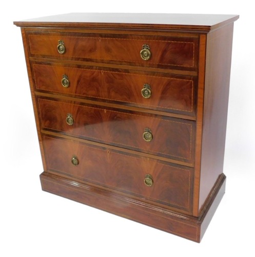 An Edwardian mahogany chest of four long graduated drawers, with herringbone and other banded inlay, raised on a plinth base, 113cm high, 114cm wide, 54cm deep.