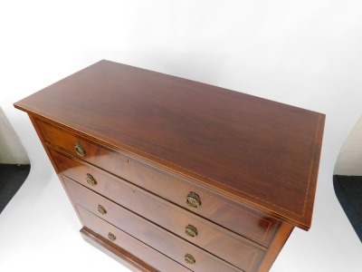 An Edwardian mahogany chest of four long graduated drawers, with herringbone and other banded inlay, raised on a plinth base, 113cm high, 114cm wide, 54cm deep. - 2