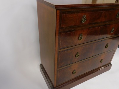 An Edwardian mahogany chest of four long graduated drawers, with herringbone and other banded inlay, raised on a plinth base, 113cm high, 114cm wide, 54cm deep. - 4