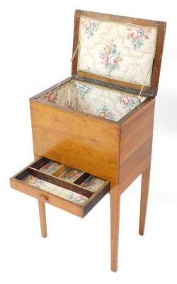 A 1930's walnut sewing table, the lift up lid enclosing a fitted interior, with a single drawer, raised on tapering, square legs, 59cm high, 34cm wide, 23cm deep.