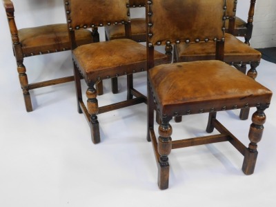 A set of six Victorian Carolean style oak dining chairs, each with a studded leather back and seat, comprising two carvers and four single chairs. - 4