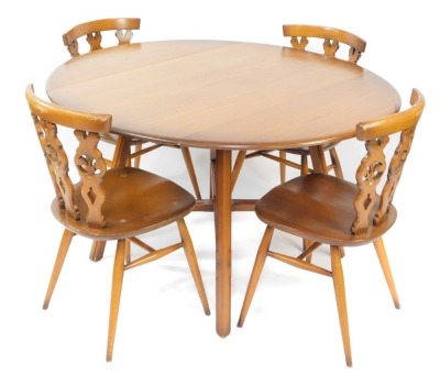 An Ercol light elm and beech kitchen dining table and four chairs, the drop flap table raised on tapering square legs, united by an x frame stretcher, with four Prince of Wales feather single dining chairs, the table 72cm high, 100cm wide, 61cm deep when