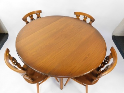 An Ercol light elm and beech kitchen dining table and four chairs, the drop flap table raised on tapering square legs, united by an x frame stretcher, with four Prince of Wales feather single dining chairs, the table 72cm high, 100cm wide, 61cm deep when - 2