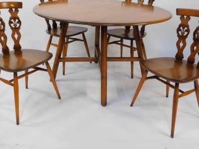 An Ercol light elm and beech kitchen dining table and four chairs, the drop flap table raised on tapering square legs, united by an x frame stretcher, with four Prince of Wales feather single dining chairs, the table 72cm high, 100cm wide, 61cm deep when - 3