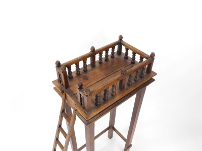 An Eastern mango wood bird feeding table, the galleried top raised on slender tapering square legs, united by a box stretcher, and a side ladder, 103cm high, 45cm wide, 28cm deep. - 2