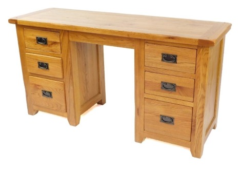 A modern oak twin pedestal desk, with a solid top over a pair of three drawer pedestals, 76cm high, 145cm wide, 49cm deep.