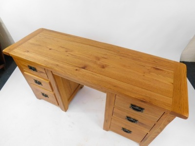 A modern oak twin pedestal desk, with a solid top over a pair of three drawer pedestals, 76cm high, 145cm wide, 49cm deep. - 2