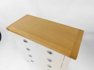 A modern oak and cream painted chest of drawers, with two short and three long drawers, on out splayed legs, 95cm high, 90cm wide, 42cm deep. - 2