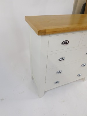 A modern oak and cream painted chest of drawers, with two short and three long drawers, on out splayed legs, 95cm high, 90cm wide, 42cm deep. - 3