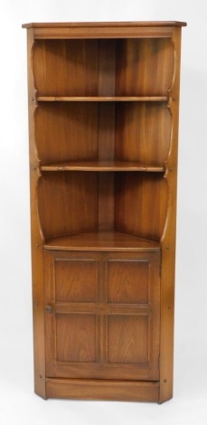 A light oak Ercol corner cabinet, with two shelf top above a panelled door, 184cm high, 74cm wide, and 56cm deep.