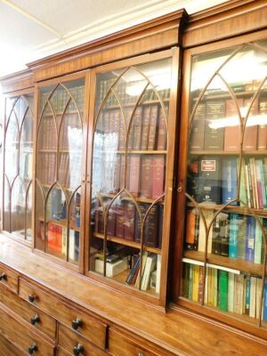 An early 19thC flamed mahogany break front cabinet and secretaire bookcase, with moulded cornice, Gothic arch astragal glazed doors to upper part, the lower having a combination of drawers, including a fitted central secretaire section with six compartmen - 3