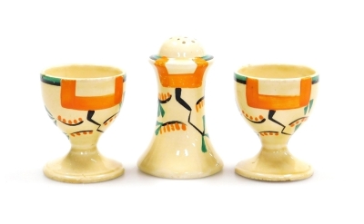 A group of Clarice Cliff Bizarre Ravel pattern wares, comprising four division egg cup stand, 16cm wide and two associated egg cups, 5.5cm high, pepper pot, 8cm high, cheese dish and cover, 19cm wide, jar, 7.5cm high (lacking lid), octagonal sandwich plat - 6