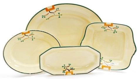 A group of Clarice Cliff Bizarre Ravel pattern wares, comprising meat plate, 41.5cm wide, oval dish, 28.6cm wide, square dish, 28cm wide, and sandwich plate, 29.5cm wide, all pieces hand painted with an abstract design in green, orange and black against 