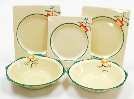 A group of Clarice Cliff Bizarre Ravel pattern wares, comprising two octagonal fruit bowls, 23cm wide, and three rectangular Biarritz plates, two 26cm wide and the other 23cm wide, all pieces hand painted with an abstract design in green, orange and black