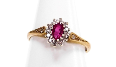 A 9ct gold pink tourmaline and diamond cluster ring, the central tourmaline stones surrounded by tiny diamonds, with diamond set shoulders in a raised basket, ring size M, 2g all in, boxed,