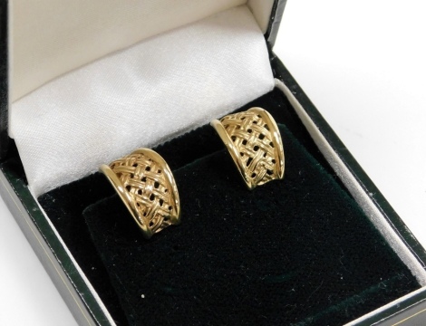 A pair of 9ct gold earrings, each rounded with tapered lattice design, on spring clip backs, 4.8g all in.