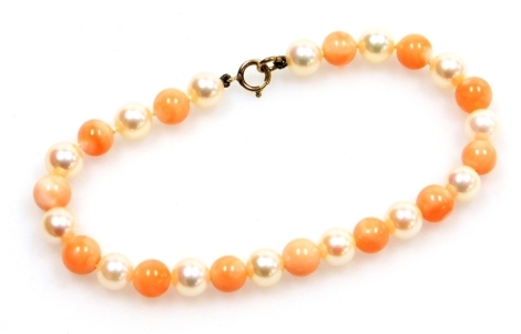 A coral and cultured pearl bracelet, on string strand with yellow metal clasp stamped 9ct, 20cm long, 10.8g all in, boxed.