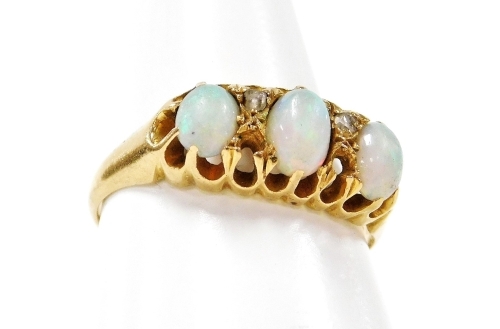 An 18ct gold opal and diamond dress ring, with three oval opals each in claw setting, and design of four diamonds, two missing, ring size M½, 3g all in. (AF)