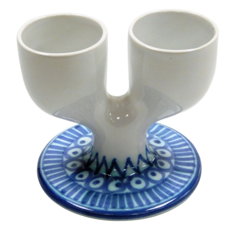 A Troika Pottery double egg cup, decorated with a two tone blue pattern of lines, circles, dots and triangles against a white ground, printed marks, 9.5cm high.