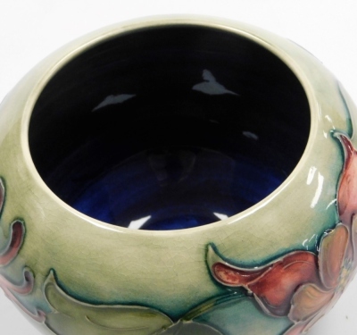 A Moorcroft pottery Columbine pattern vase, of squat bulbous form, printed marks and paper label, 8cm high. - 2