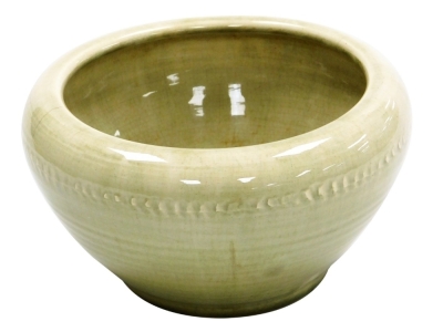 A Moorcroft pottery bowl, in a pale green glaze decorated with a raised band of vertical markings, impressed marks, 11cm high, 18.5cm diameter.